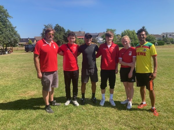 Stephan Faber, Barth, Maro Aurélio Torres, Simon, Lisa, Rodrigo Torres stehen glücklich auf dem Feld, auf dem Sie Fußball trainiert haben.